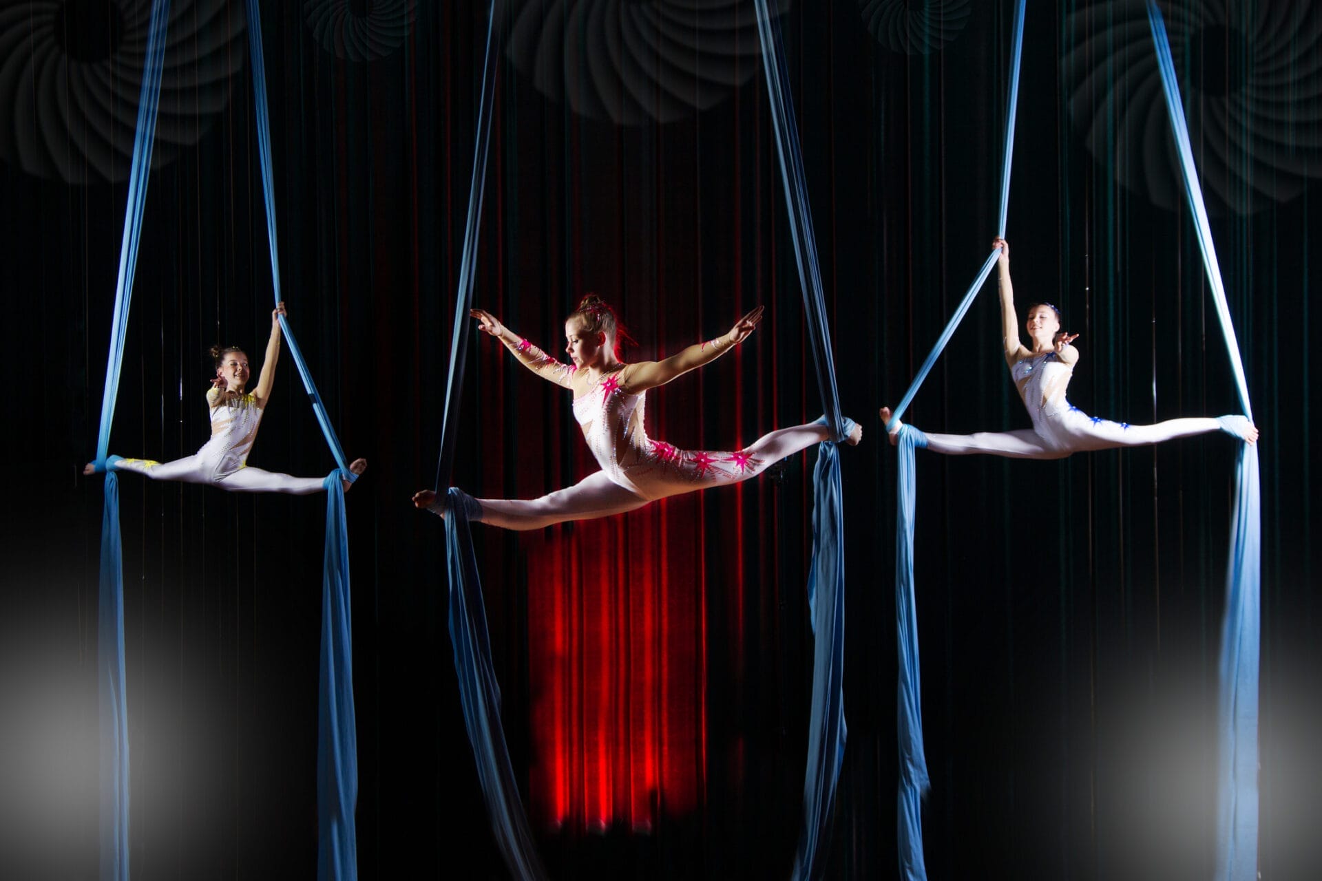 Circus Actress Acrobats Performance On Canvases. Team Girls Perform Acrobatic Elements In The Air.