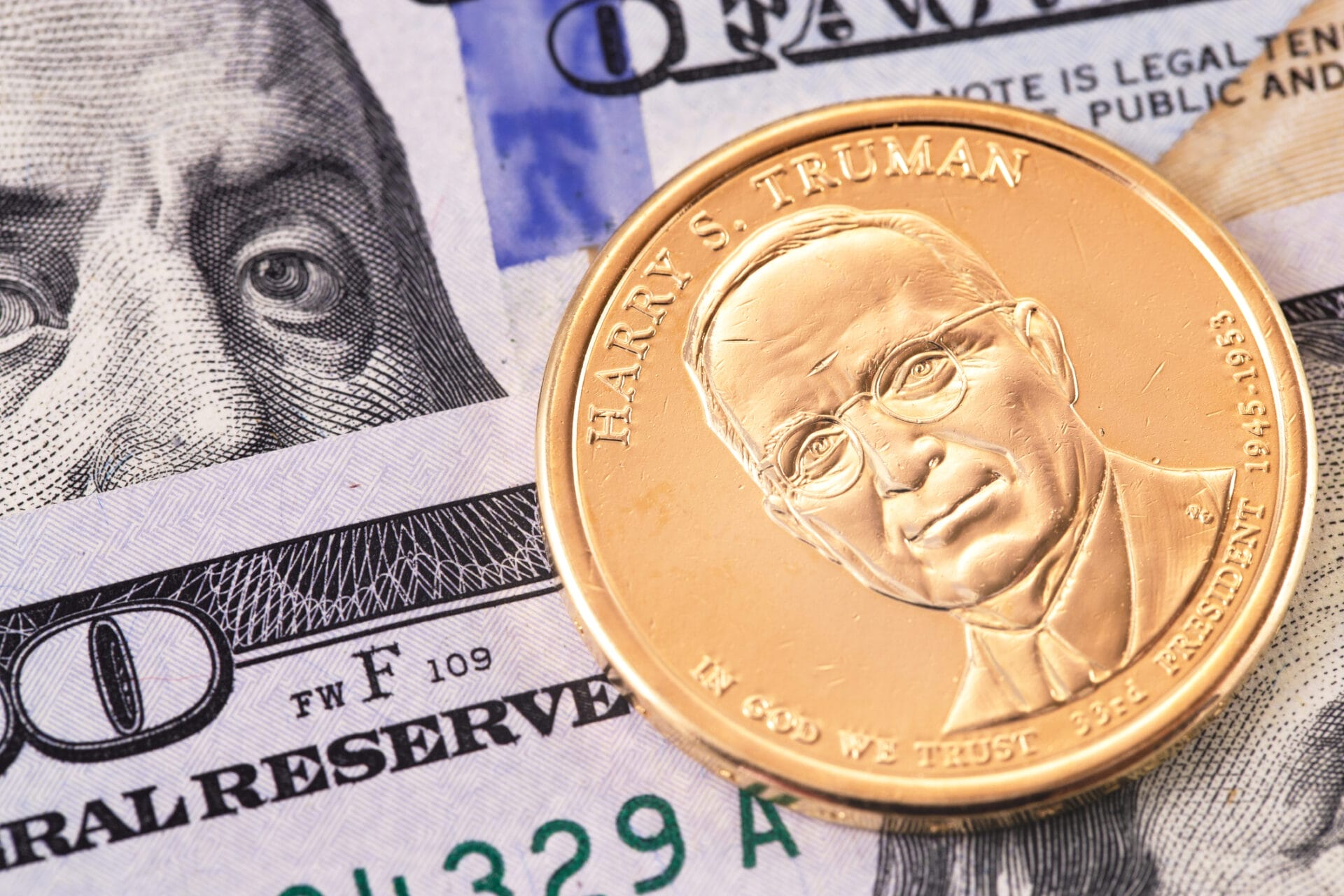 One Dollar Golden Coin With Harry S. Truman Portrait, And Hundred Dollars Banknotes, Macro